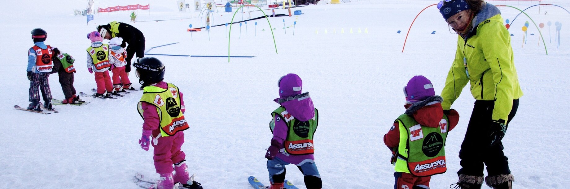 a person and young kids skiing
