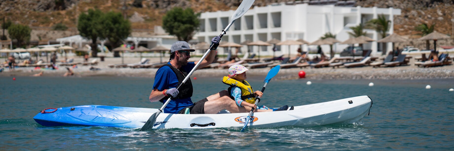a couple of people in a kayak on a lake