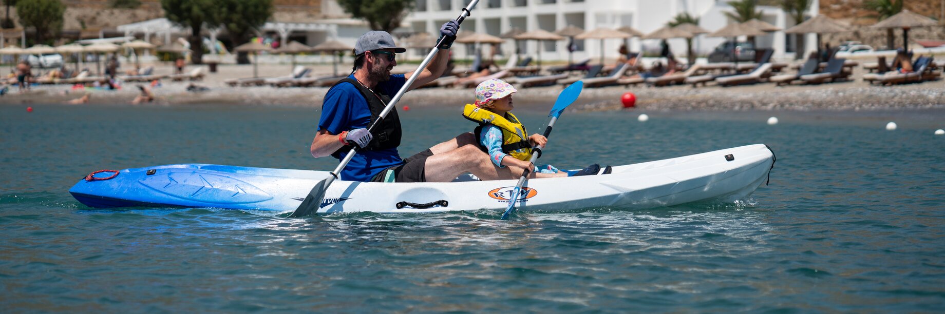 a couple of people in a kayak on a lake