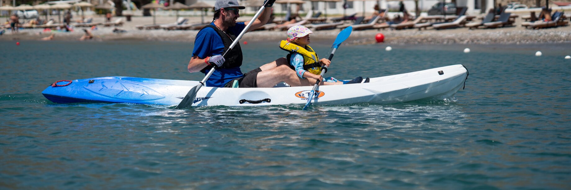 a couple of people in a kayak on a lake