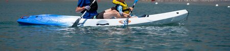 a couple of people in a kayak on a lake