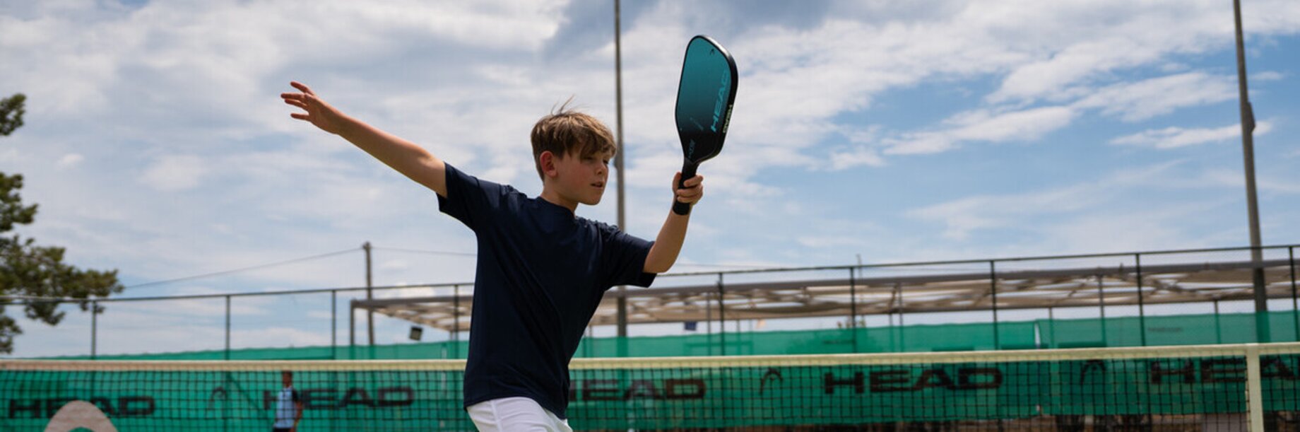 Young boy playing pickleball