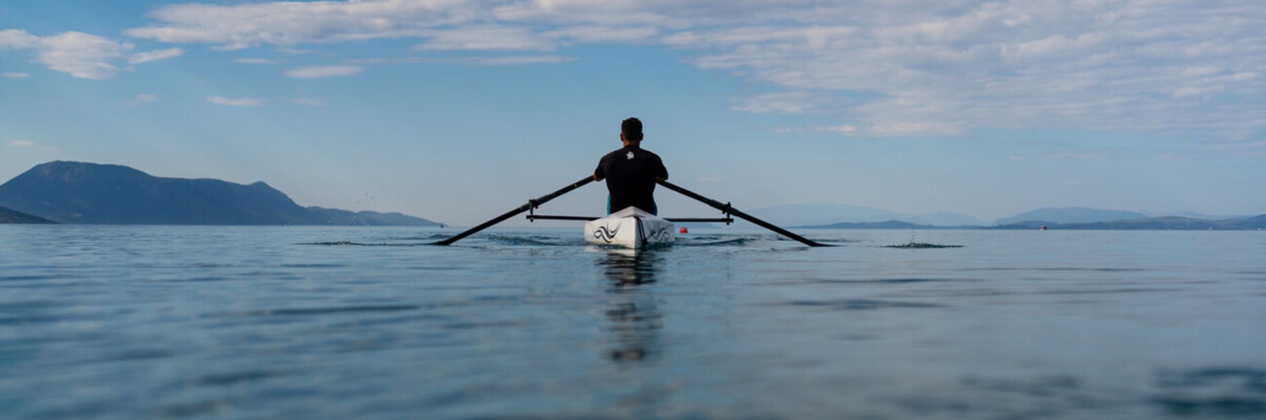 Rowing on the horizon blue skies blue sea