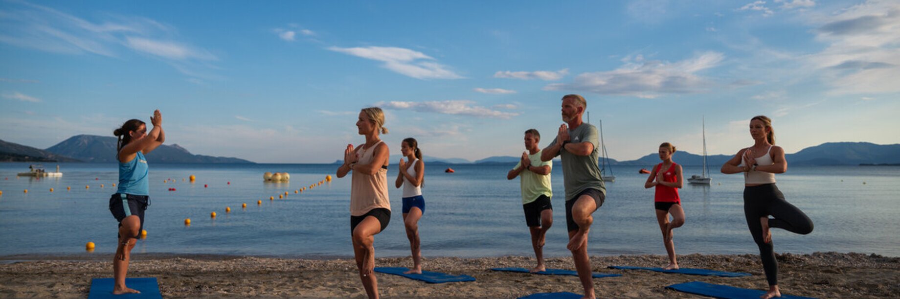 One leg yoga pose on beach
