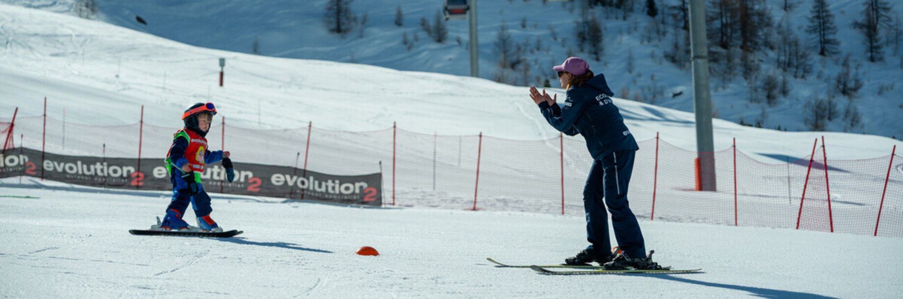 A ski lesson with a young child learning to ski