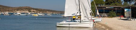 Waterfront with two dinghy sailing boats at Phokaia Beach Resort, Turkey