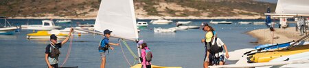 Children getting onto a dinghy sailing boat at Phokaia Beach Resort