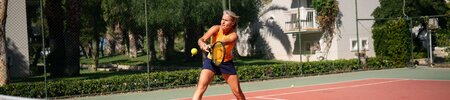 A woman playing tennis at Phokaia Beach Resort, Turkey