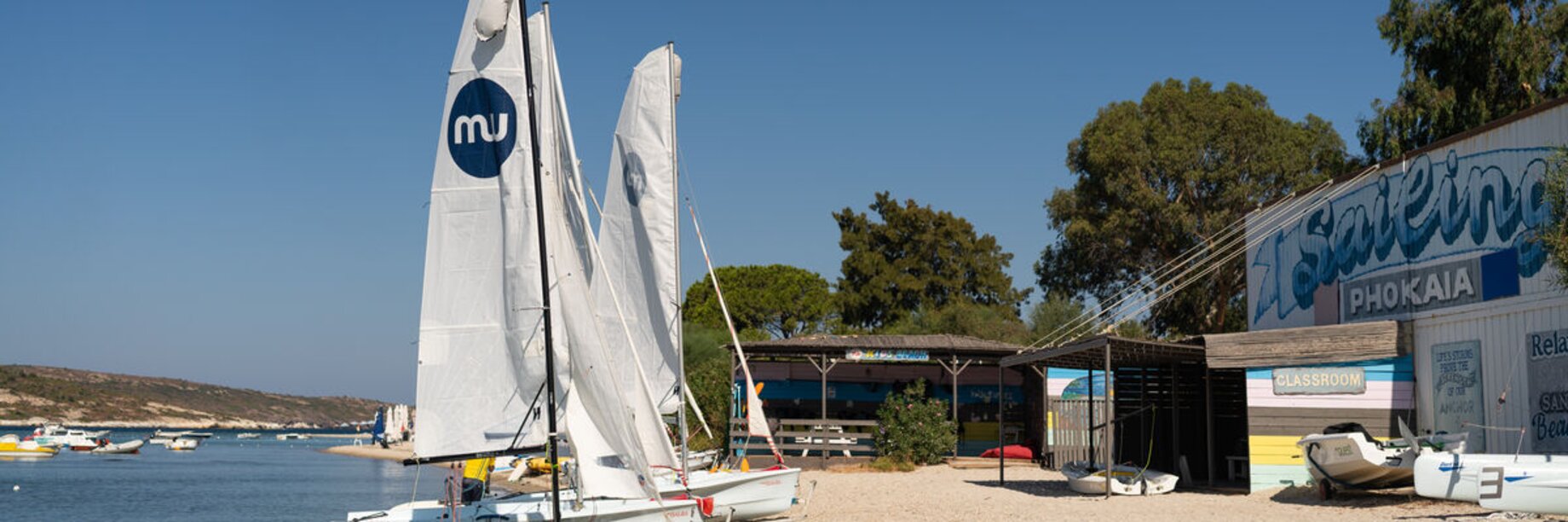Waterfront with dingy sailing boats at Phokaia Beach Resort, Turkey