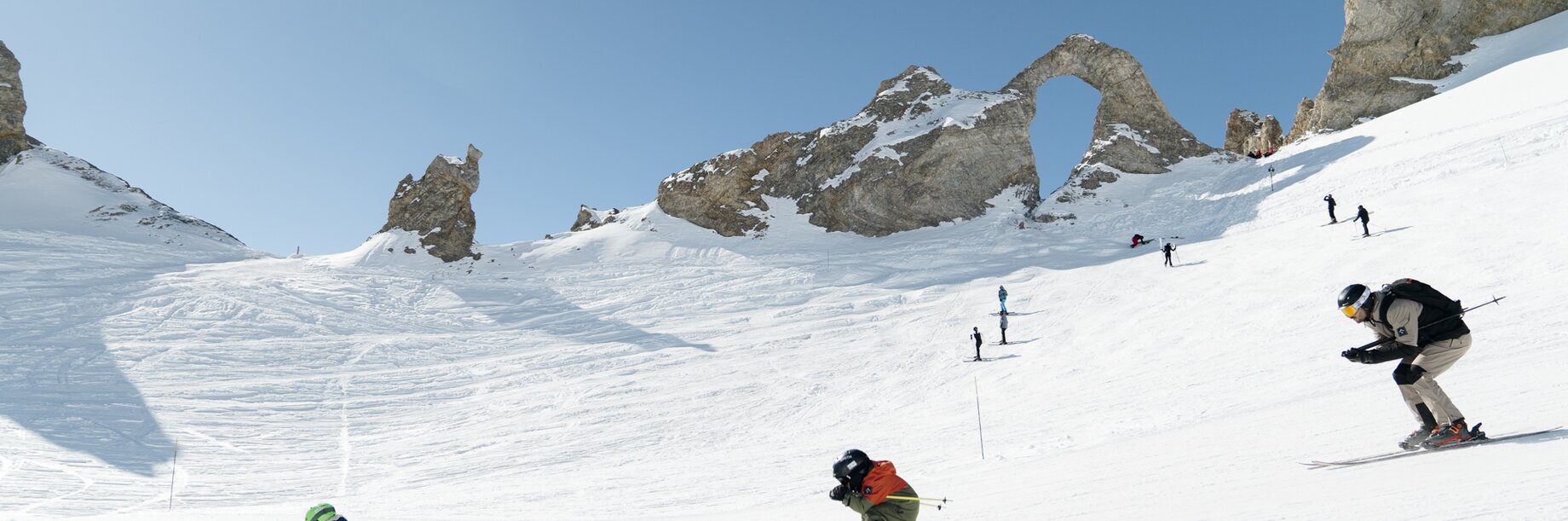 Family skiing past the eye in Tignes