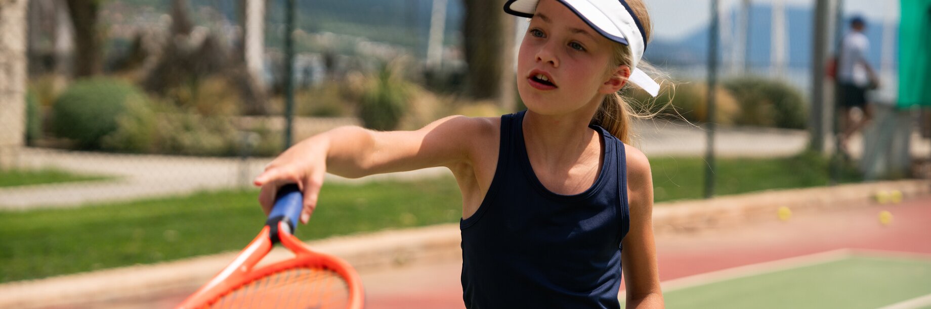 girl serving in tennis game