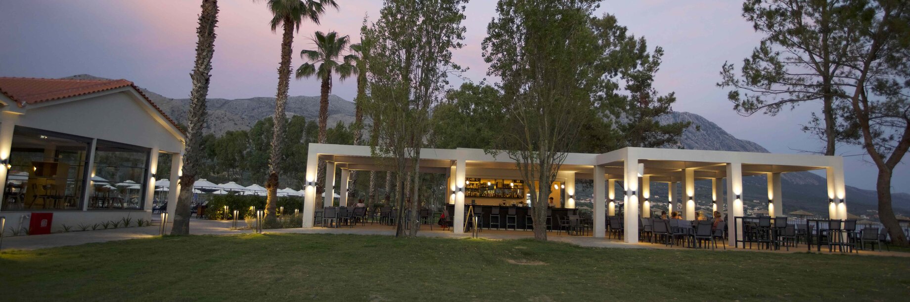 a building with trees and grass