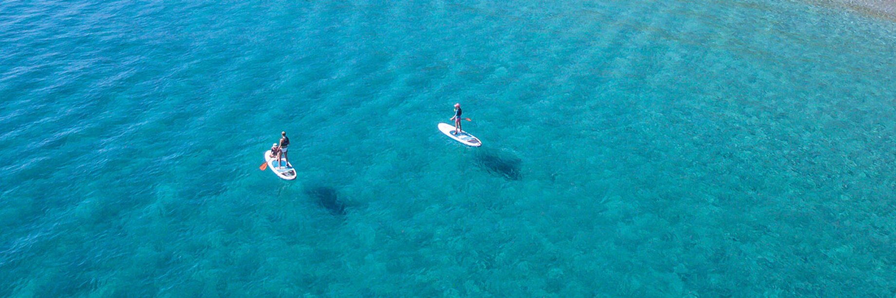 two people on boats in the water