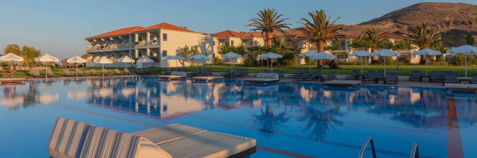 Sunrise at Aeolian Village Beach Resort, Lesvos with a view of the hotel rooms and main pool