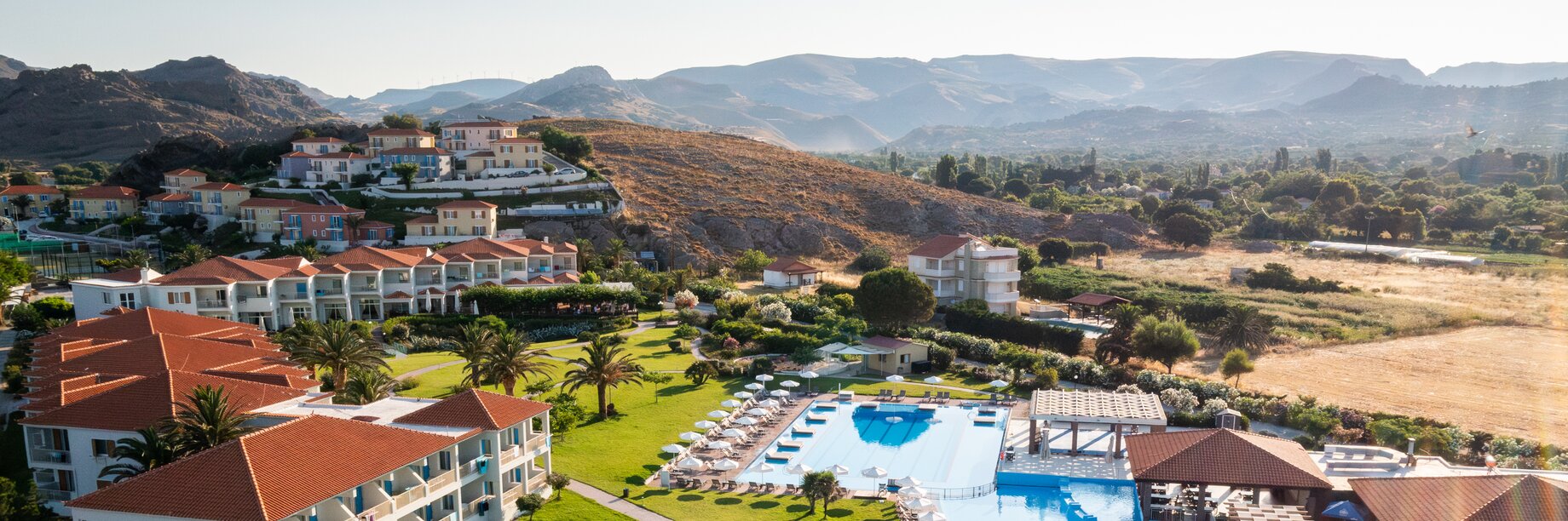 Drone view of Aeolain Village Resort up to the village rooms and beyond